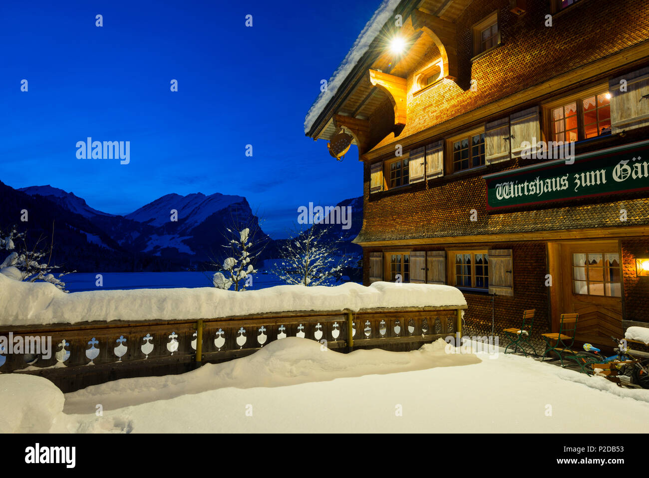 snow covered tavern at night, Schoppernau, Bregenz district, Vorarlberg, Austria Stock Photo