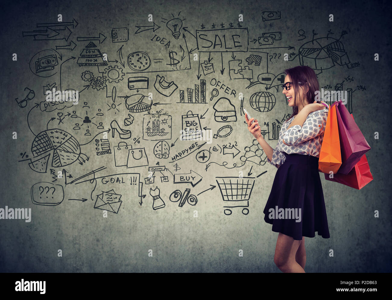 Side view of beautiful girl shopping via smartphone standing with paper bags smiling happily making plans and calculations Stock Photo