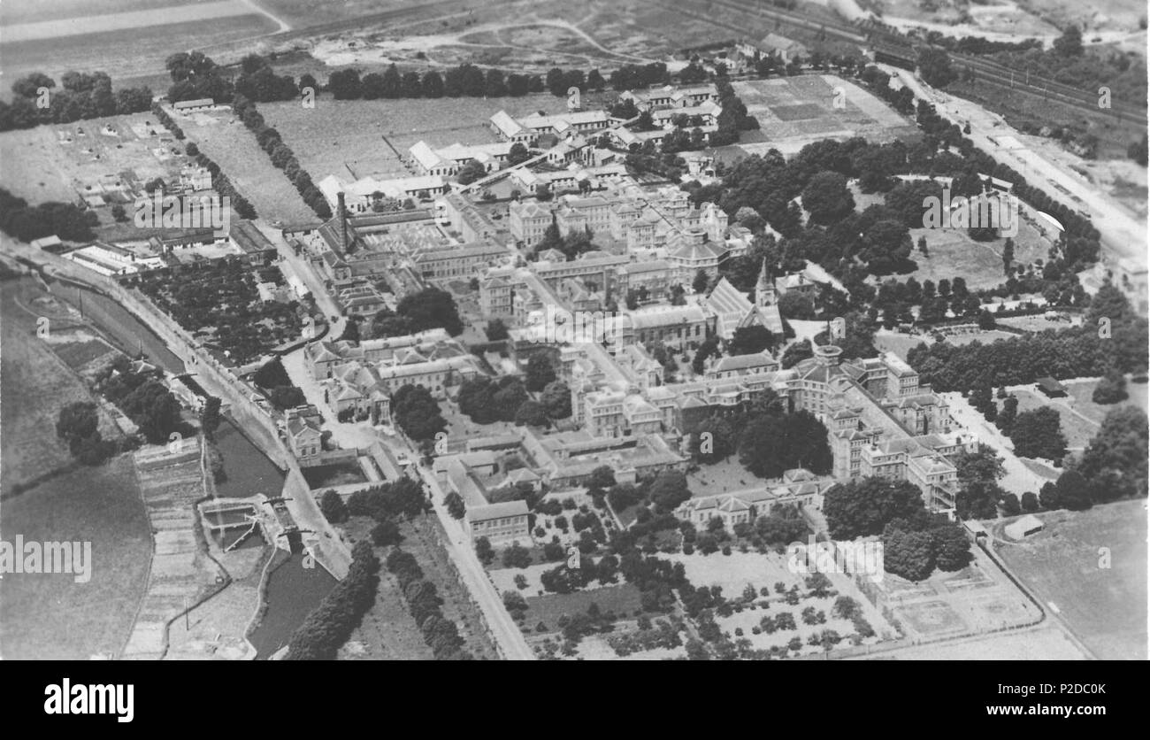 . English: This photograph shows St. Bernard's hospital when it was called the County Mental Hospital, Hanwell. The area shown is covered by Grid Ref: 514552,179994 ( TQ 145 799 GB Grid) Taken in the first half of the 1920's one can see that the large nurses home has still not been built in the top right corner of the frame. It has since been demolished. Further to the top right is the Iron Bridge at the junction of Uxbridge Road ( A 4020) and Windmill Lane (A 4127) which runs south to the left of the frame. Running down the left-hand side is a section of the 'Flight of Locks' on the Grand Uni Stock Photo