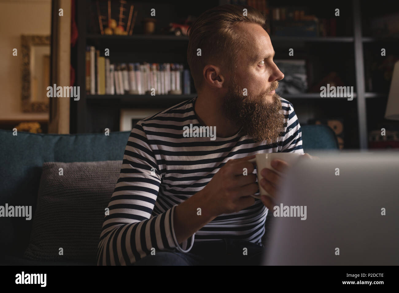 Thoughtful man looking away while having coffee Stock Photo