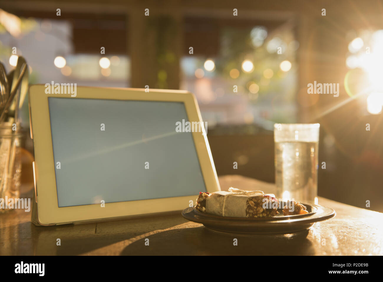 Digital tablet and breakfast on table Stock Photo