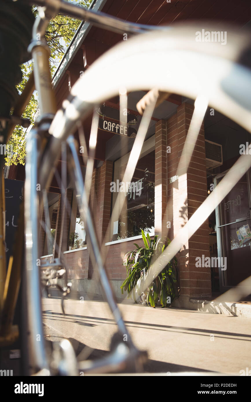 View of coffee shop through bicycle tyre Stock Photo