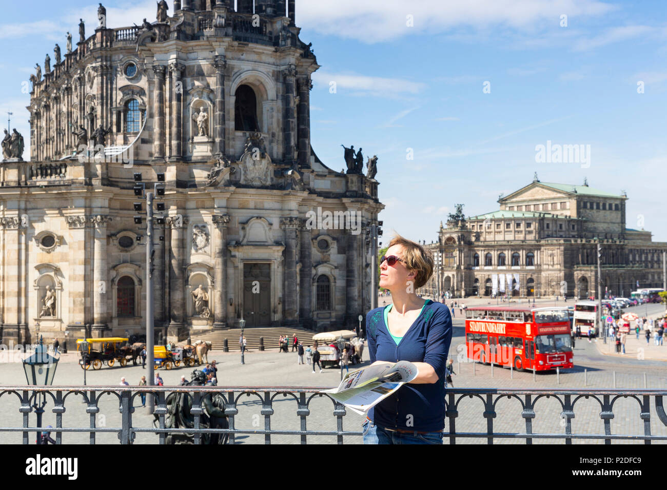 Female tourist with city map, guide book, view from Bruehl's Terrace towards Dresden cathedral, Catholic Court Church and Semper Stock Photo