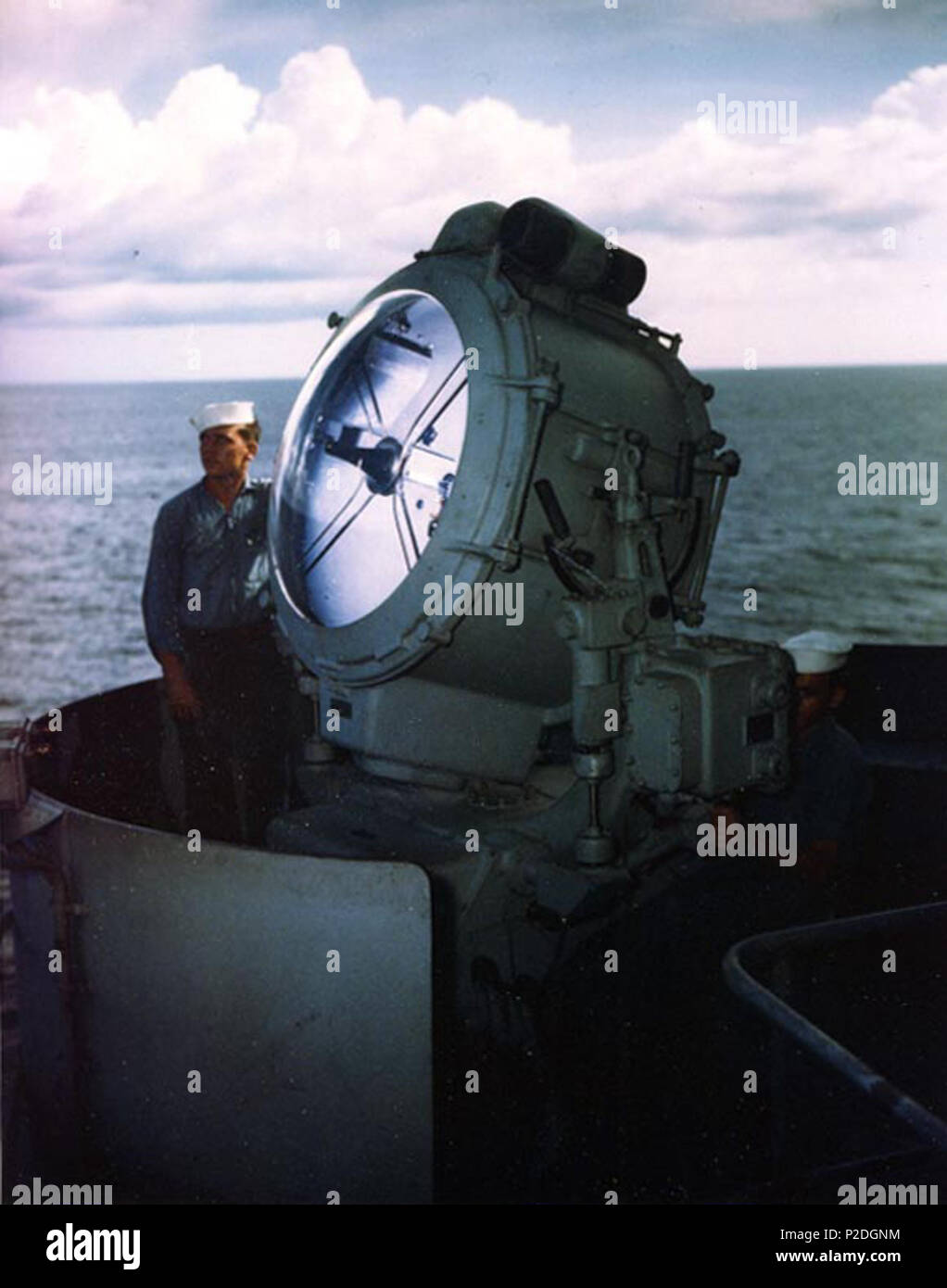 . U.S. Electricians's Mate First Class Kenneth McNally and Seaman First Class George Skiratko operate a 36-inch (91.4 cm) searchlight aboard the battleship USS Missouri (BB-63), during the ship's shakedown cruise, circa August 1944. circa August 1944. USN 51 Searchlight aboard USS Missouri (BB-63) 02 in 1944 Stock Photo