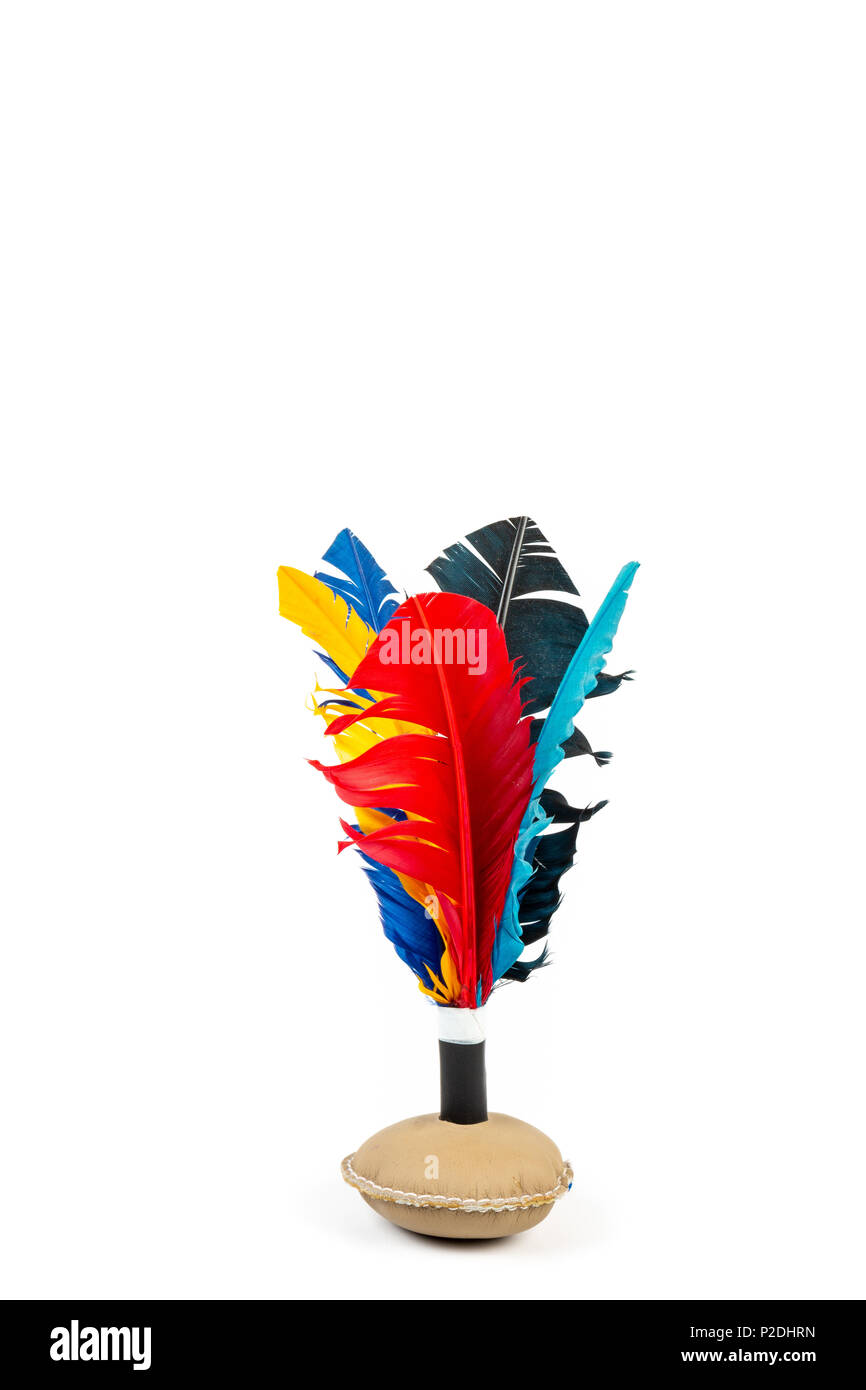 Close up of handmade shuttlecock toy with colorful feathers on white background. Stock Photo