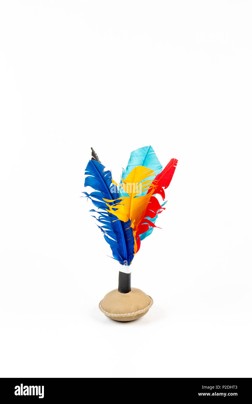 Close up of handmade shuttlecock toy with colorful feathers on white background. Stock Photo