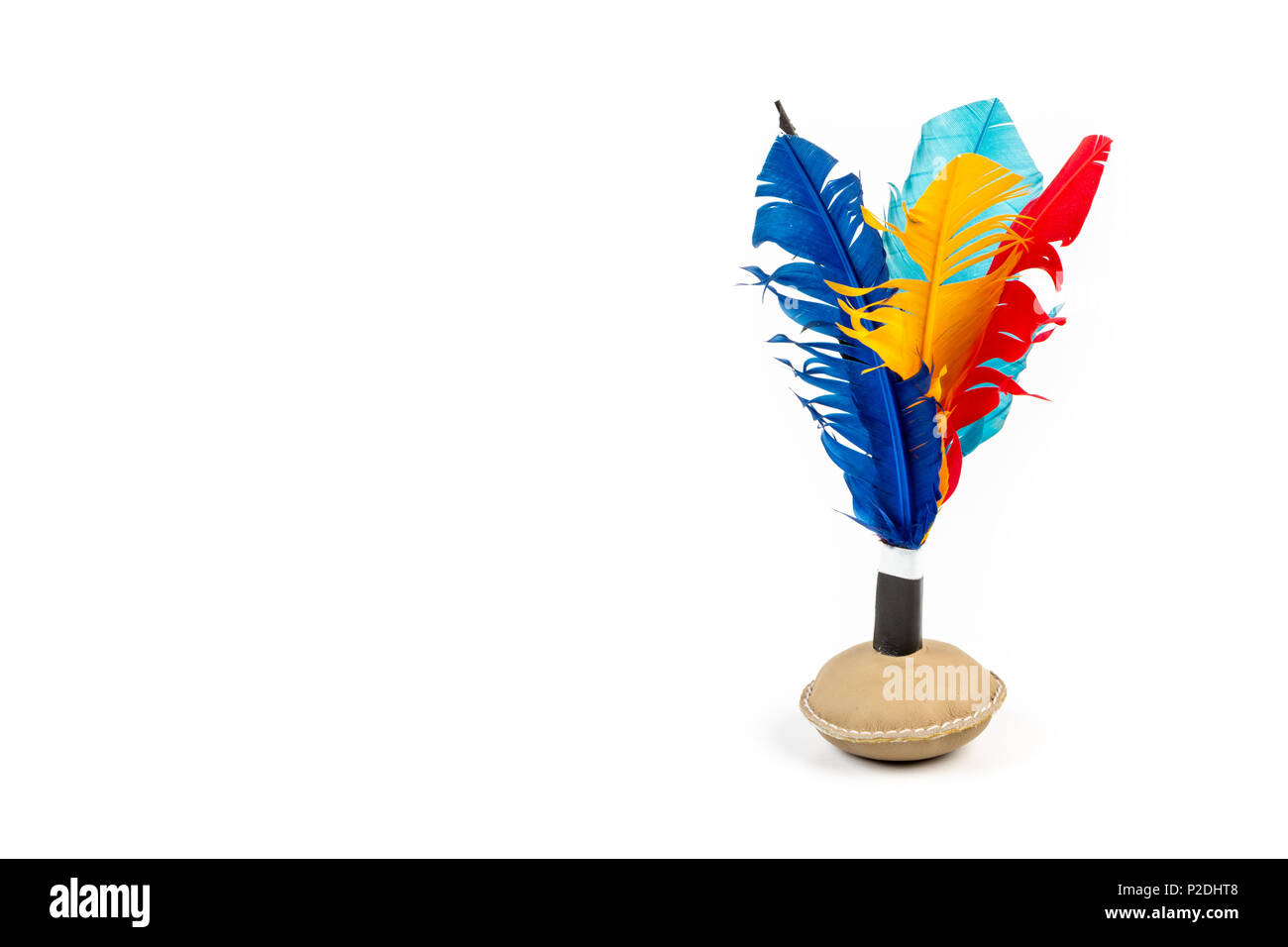 Close up of handmade shuttlecock toy with colourful feathers on white background. Stock Photo