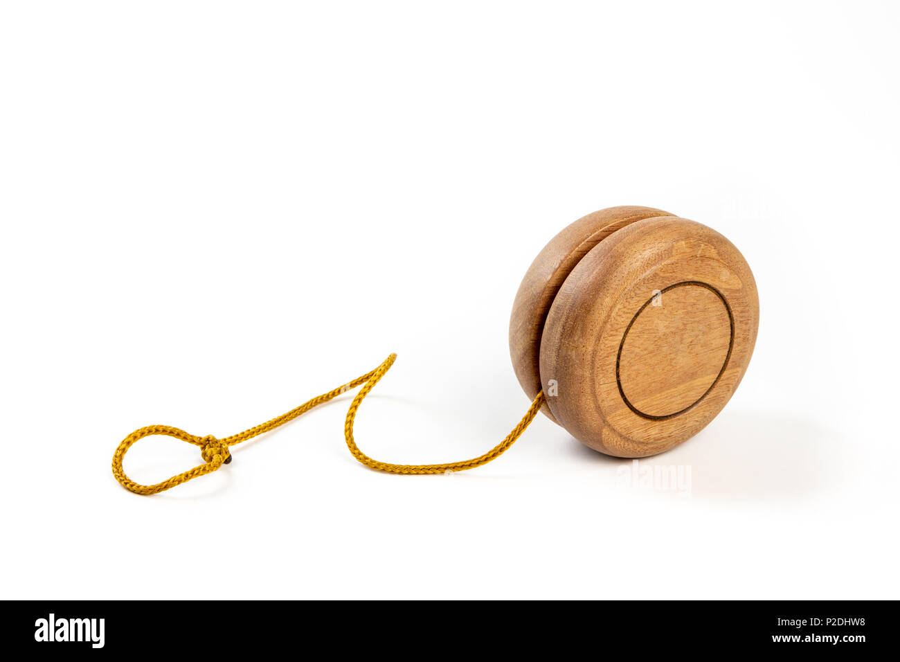 Close up of a wooden yo-yo with yellow string on white background Stock  Photo - Alamy