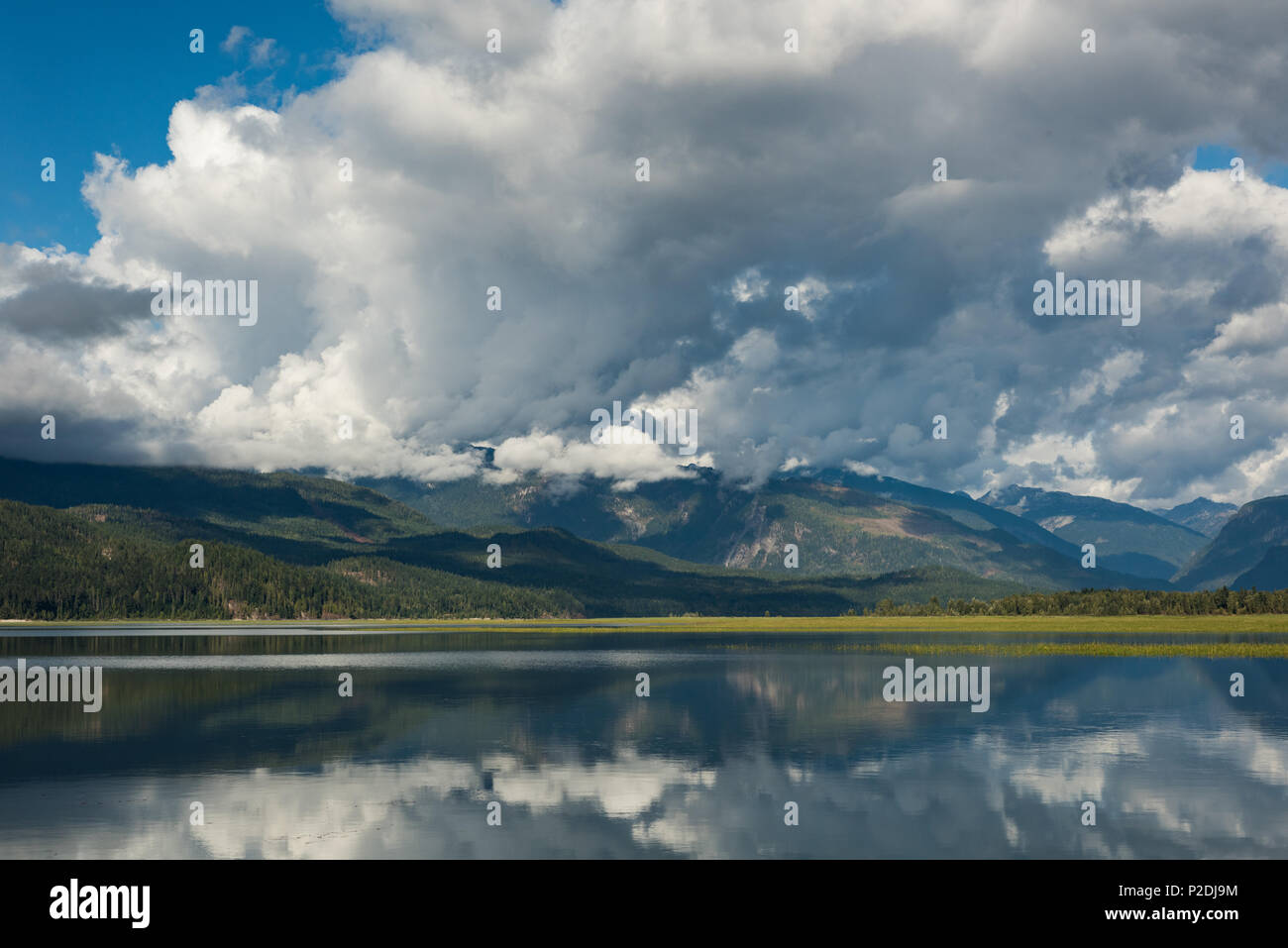 Cloudy sky over green mountains and river Stock Photo - Alamy