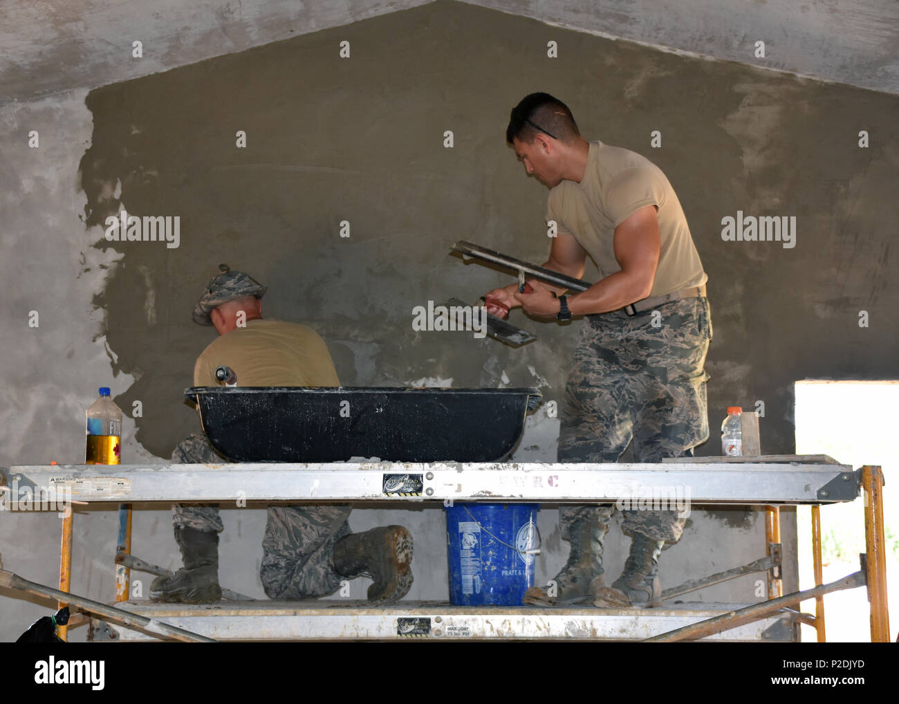 Second Lieutenant Michael Lozy (right) and Master Sgt. David Guilmette from the 143d Civil Engineering Squadron (CES), Rhode Island Air National Guard skim coats a cement mix which strengthens walls for extreme weather conditions in Inarajan, Guam during an Innovative Readiness Training (IRT) project on September 2, 2016.  The IRT project, in conjunction with Habitat for Humanity Guam is to provide two homes for residents in Inarajan.  The members are part of a 36 Airmen crew from a cross section of trades within the CES.  U.S. Air National Guard photo by Master Sgt. John V. McDonald Stock Photo