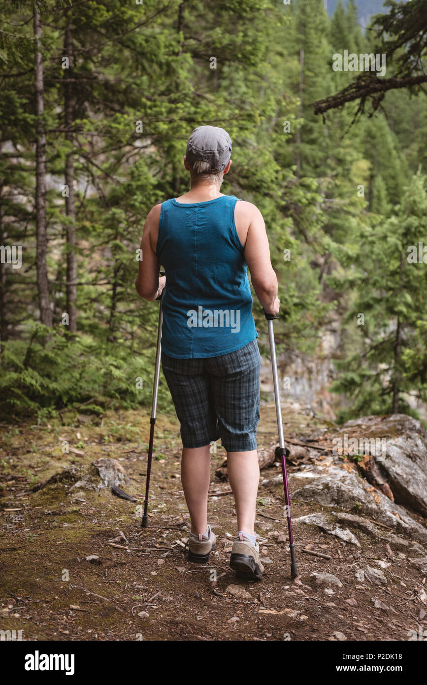 Mature woman hiking in forest Stock Photo - Alamy