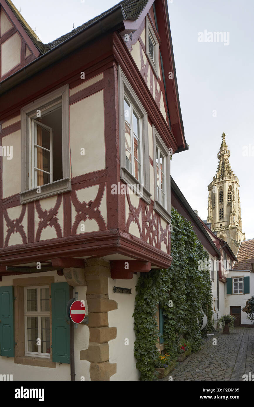 Half-timbered house and spire of the castle church, Meisenheim, Administrative district of Bad Kreuznach, Region of Nahe-Hunsrue Stock Photo