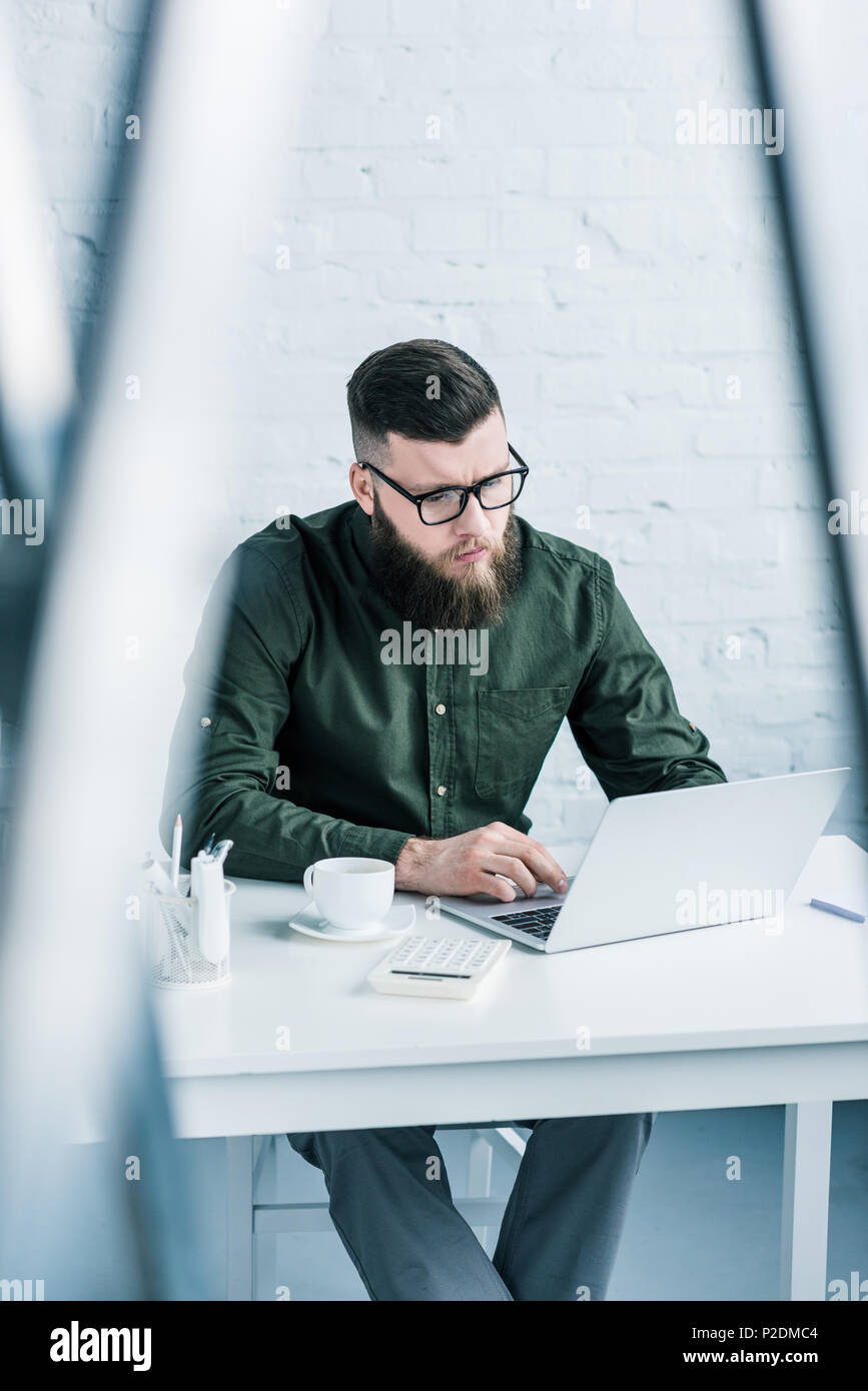 portrait of focused businessman working on laptop at workplace Stock ...
