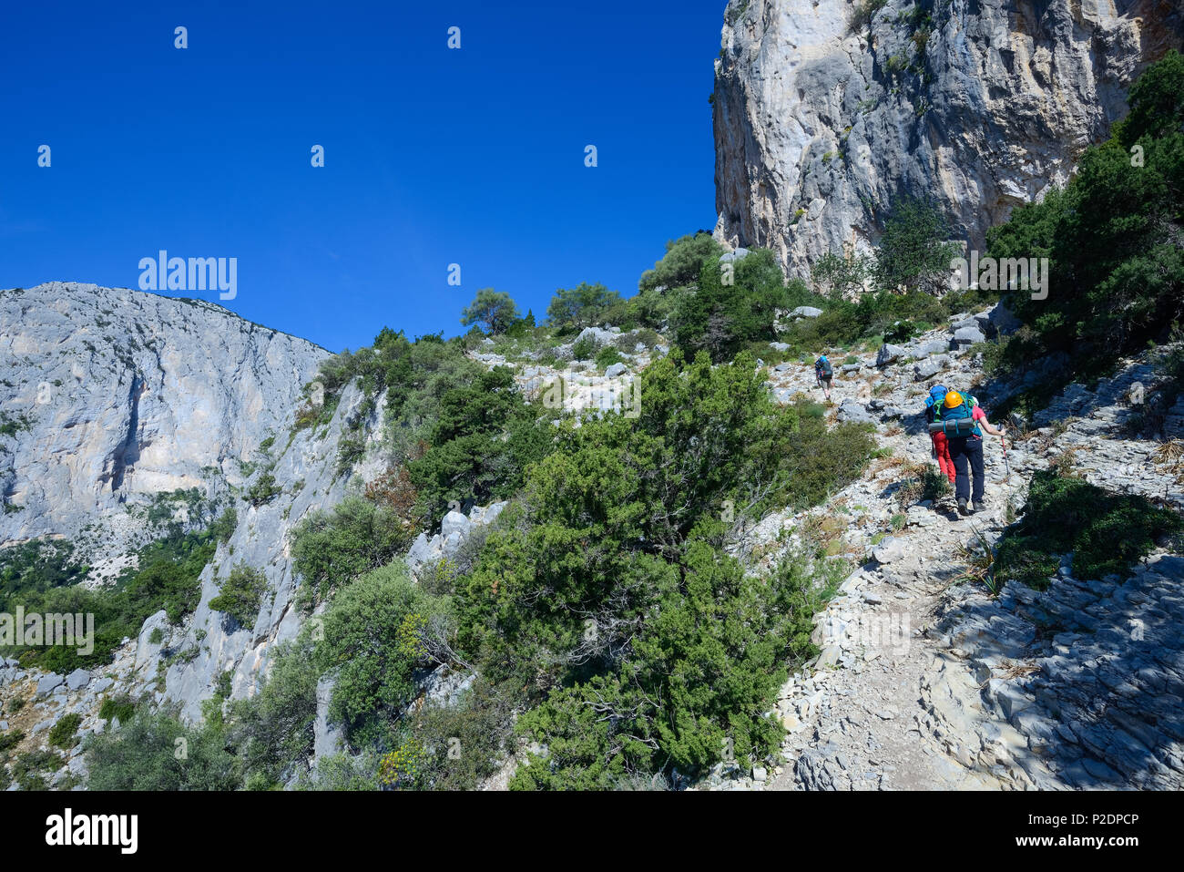 Two young women and a young man hiking through the mountainous coastline, Selvaggio Blu, Sardinia, Italy, Europe Stock Photo