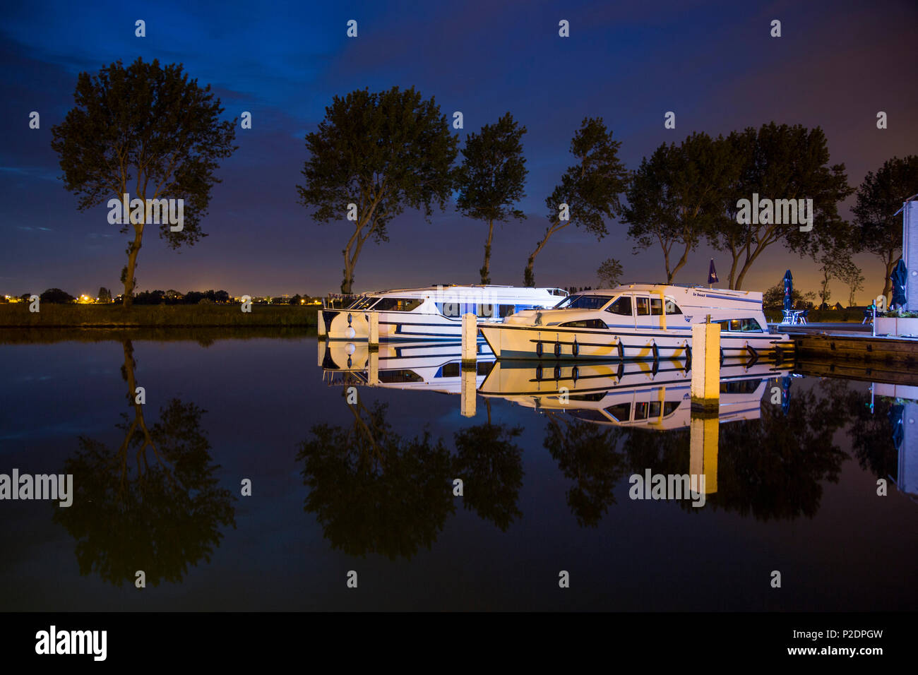 Le Boat Royal Mystique and Vision 3 houseboats at Westhoek Marina at night, Nieuwpoort, Flemish Region, Belgium Stock Photo