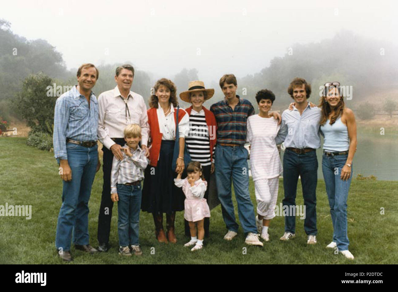 . English: The Reagan Family at Rancho Del Cielo: (left to right) Michael Reagan, President Reagan, Cameron Reagan, Colleen Reagan, Nancy Reagan, Ashley Marie Reagan, Ron Reagan, Doria Reagan, Paul Grilley, Patti Davis. Português: A Família Reagan no Rancho Del Cielo: (da esquerda para a direita) Michael Reagan, President Reagan, Cameron Reagan, Colleen Reagan, Nancy Reagan, Ashley Marie Reagan, Ron Reagan, Doria Reagan, Paul Grilley e Patti Davis. 17 August 1985. Unknown 62 The Reagan Family at Rancho Del Cielo Stock Photo