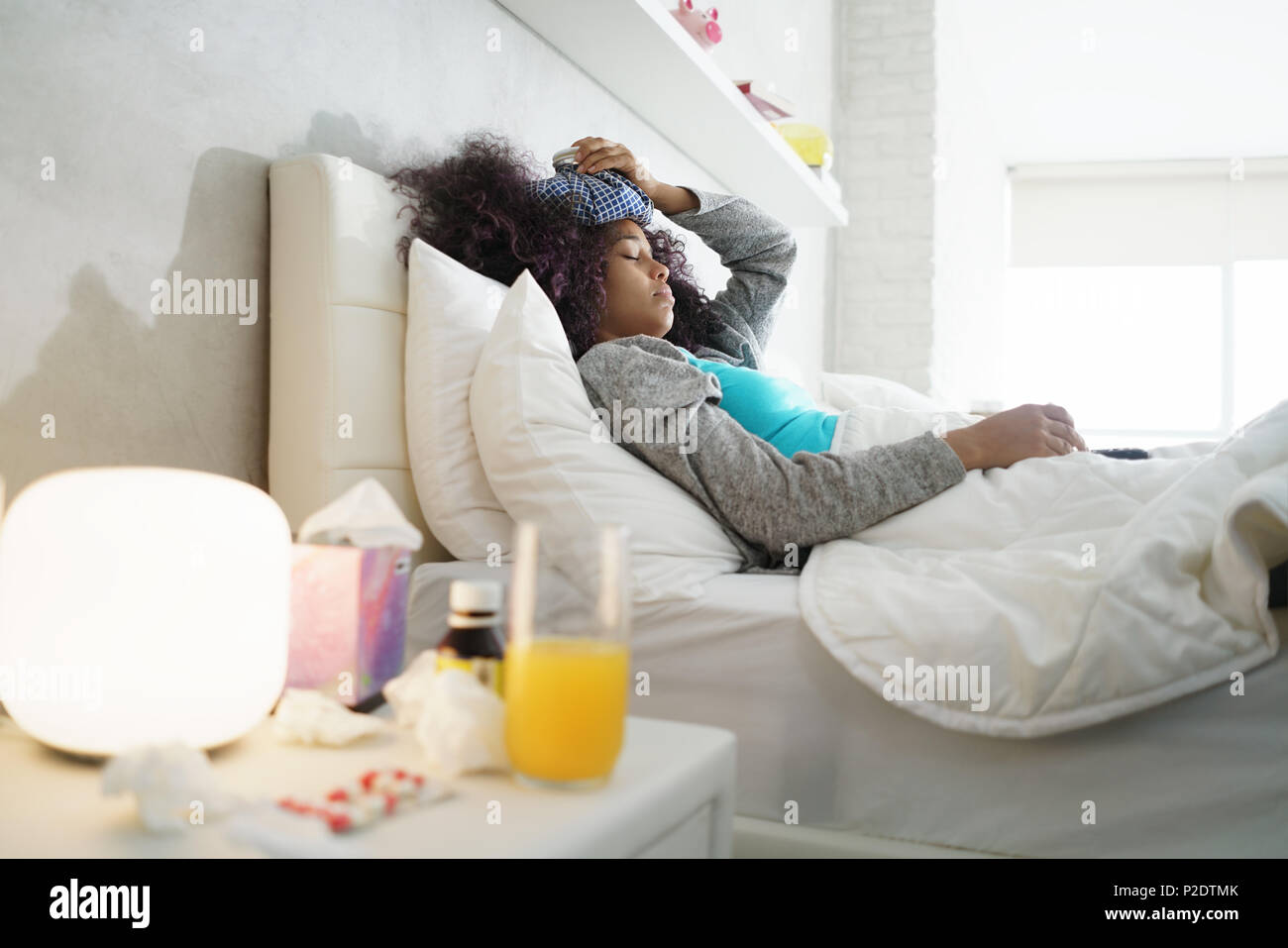 Black Woman With Flu And Cold Holding Ice Bag Stock Photo