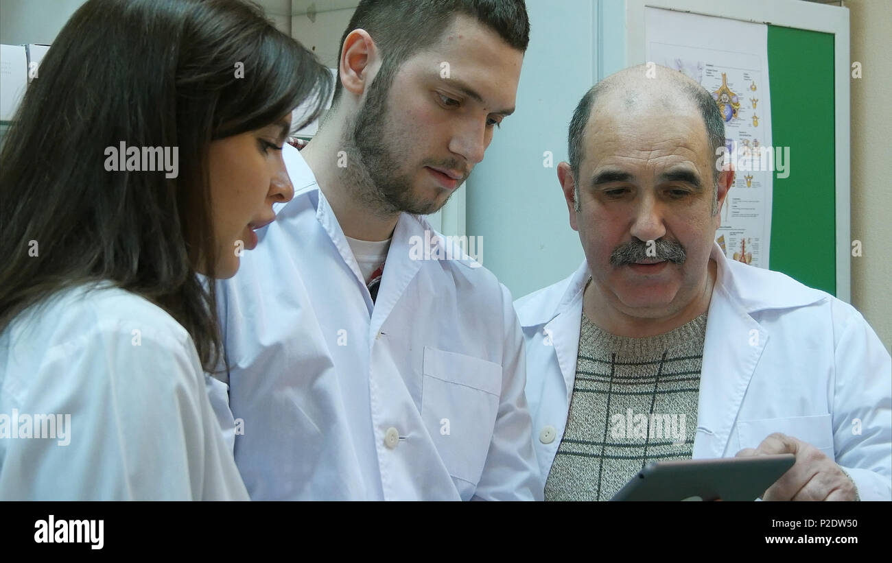 Pharmacists using digital tablet while checking medicine in pharmacy Stock Photo