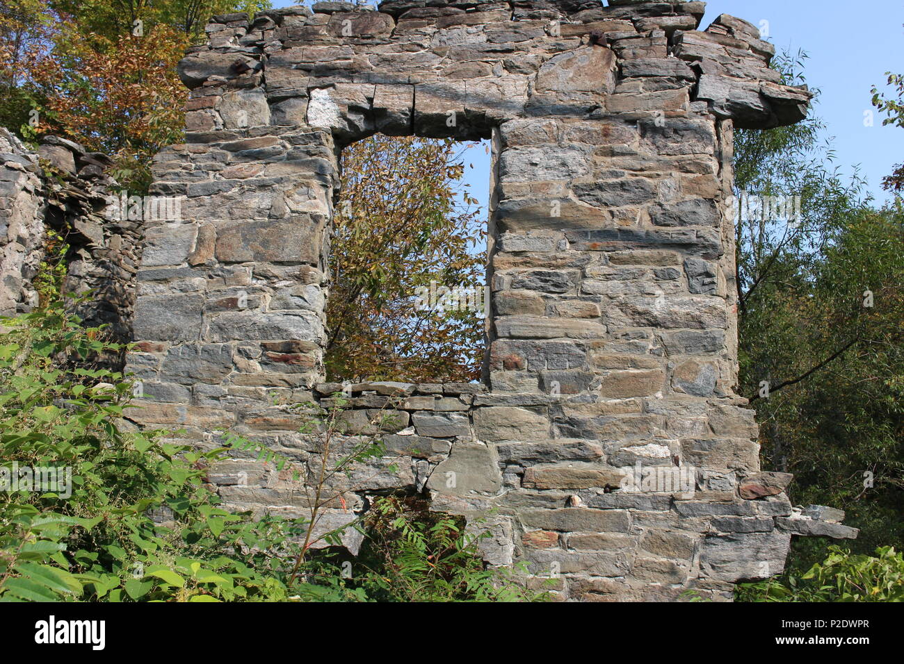 This is a wall of an old stone mill in a tiny Vermont village, it is over 100 years old. Stock Photo