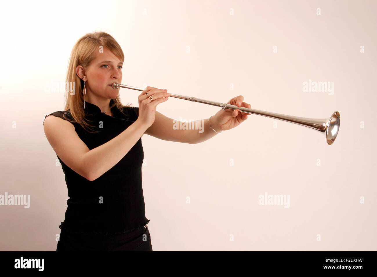 Posthorn in playing position. Brass. Development of the trumpet. model release - Gemma Jones Stock Photo