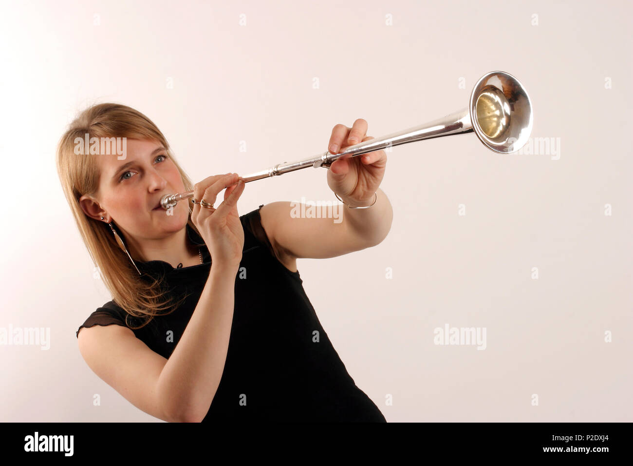 Posthorn in playing position. Brass. Development of the trumpet. model release - Gemma Jones Stock Photo