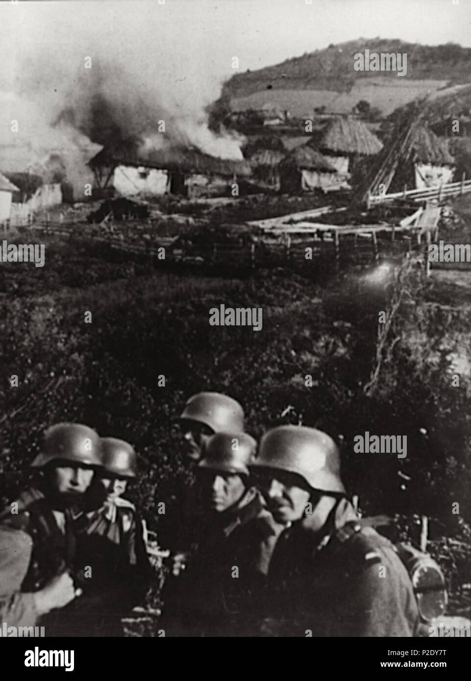 . Germans set fire to a Serbian village near Kosovska Mitrovica. 1941. Unknown 10 Burning village Serbia 1941 Stock Photo