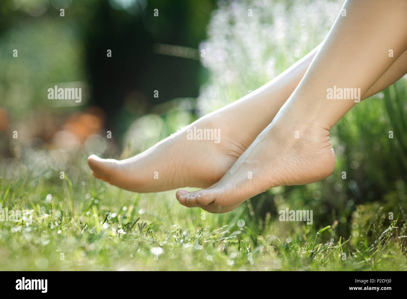 female legs walking on green grass Stock Photo - Alamy