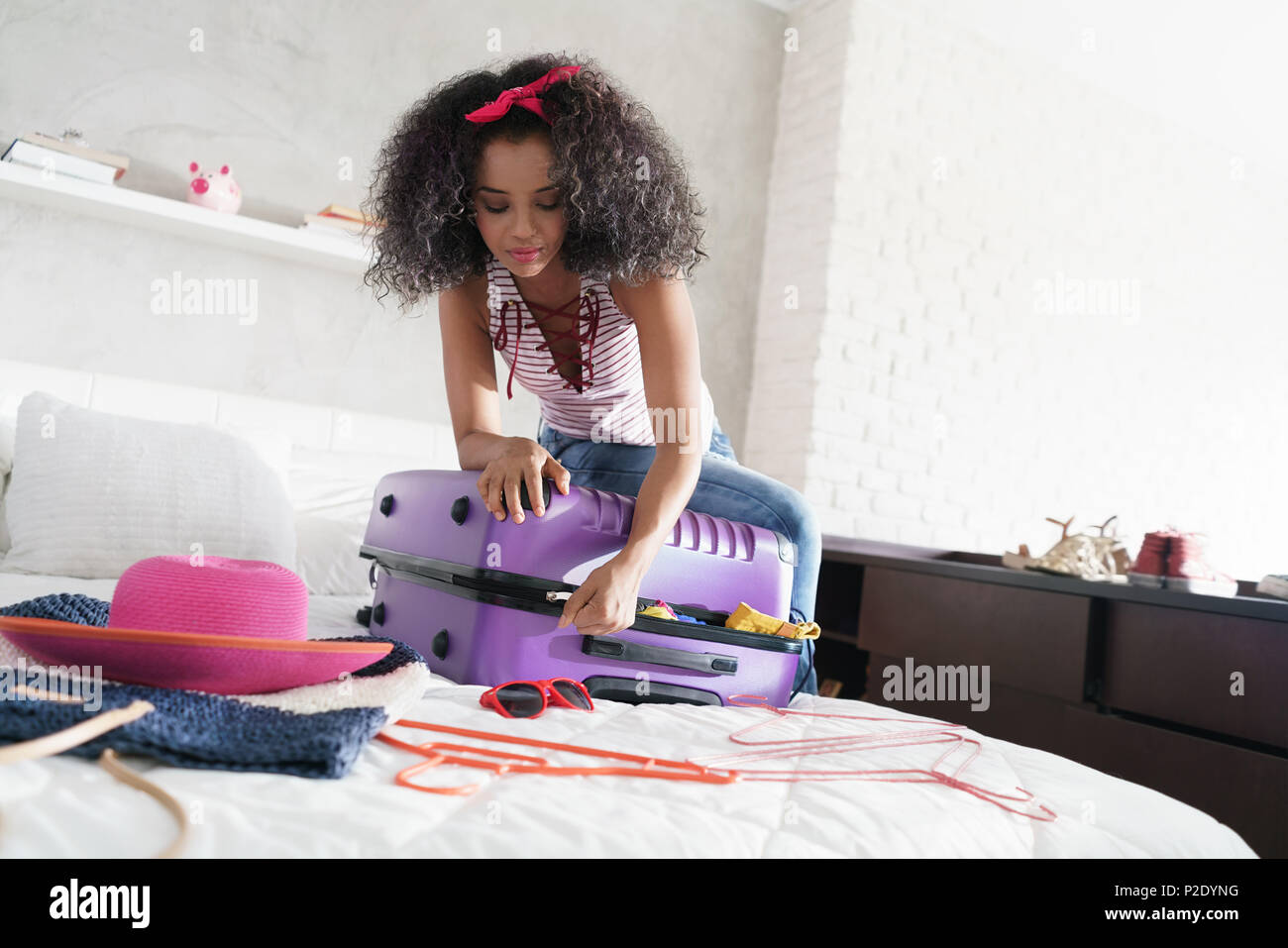 African American Girl Preparing Baggage For Vacation And Travel Stock Photo