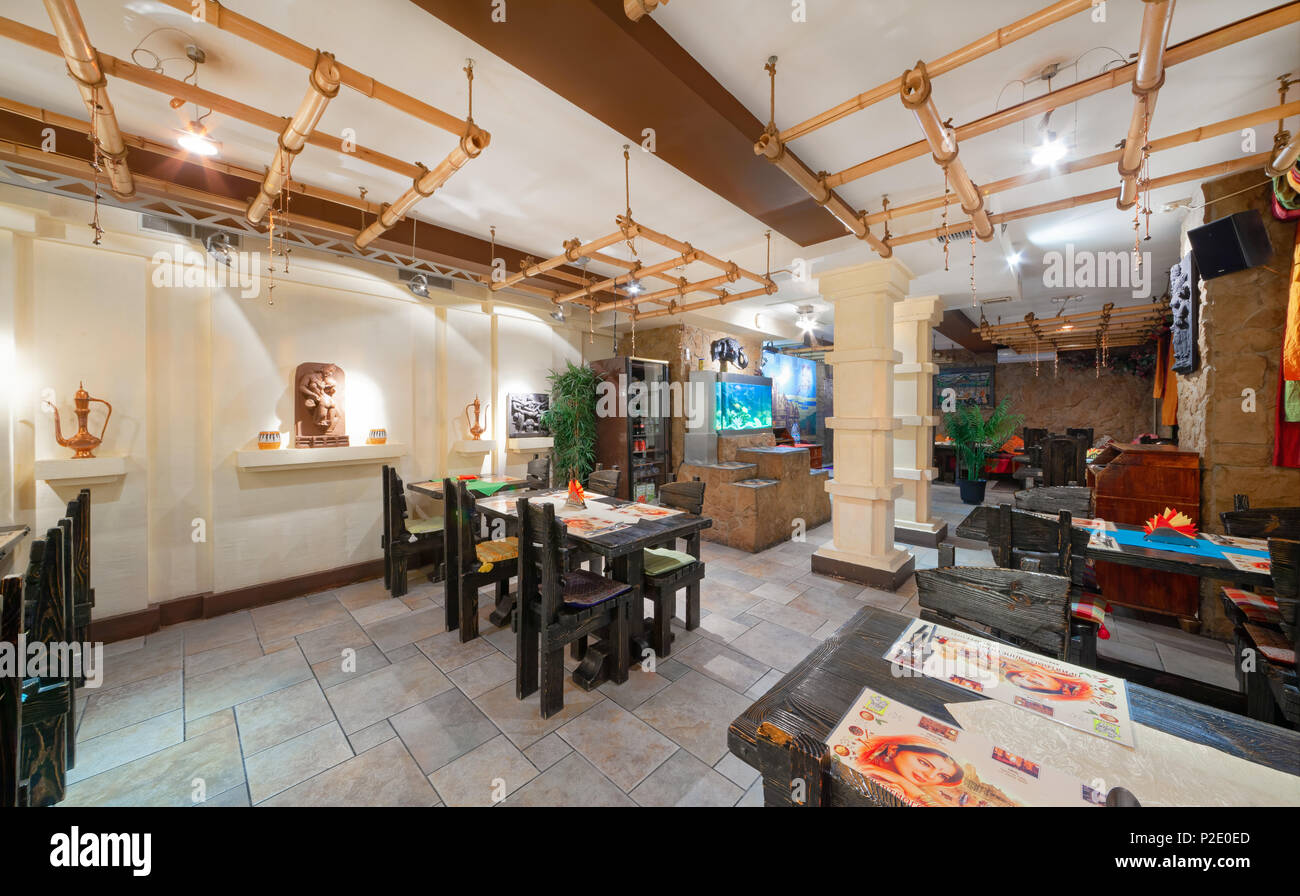 MOSCOW - SEPTEMBER 2014: Interior and furnishings of the restaurant of Indian cuisine 'KHAJURAHO'. Hall with wooden furniture decorated in ethnic styl Stock Photo