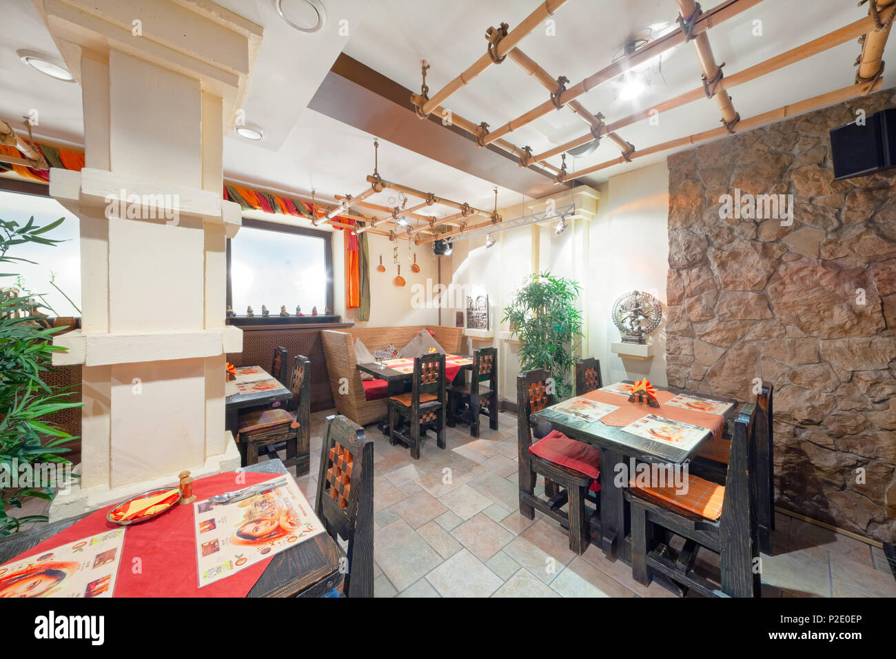 MOSCOW - SEPTEMBER 2014: Interior and furnishings of the restaurant of Indian cuisine 'KHAJURAHO'. Hall with wooden furniture decorated in ethnic styl Stock Photo