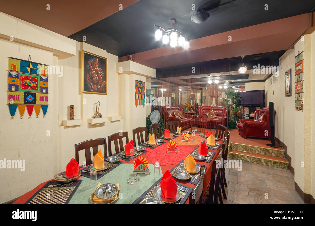 MOSCOW - SEPTEMBER 2014: Interior and furnishings of the restaurant of Indian cuisine 'KHAJURAHO'. Long served table in the banquet hall Stock Photo