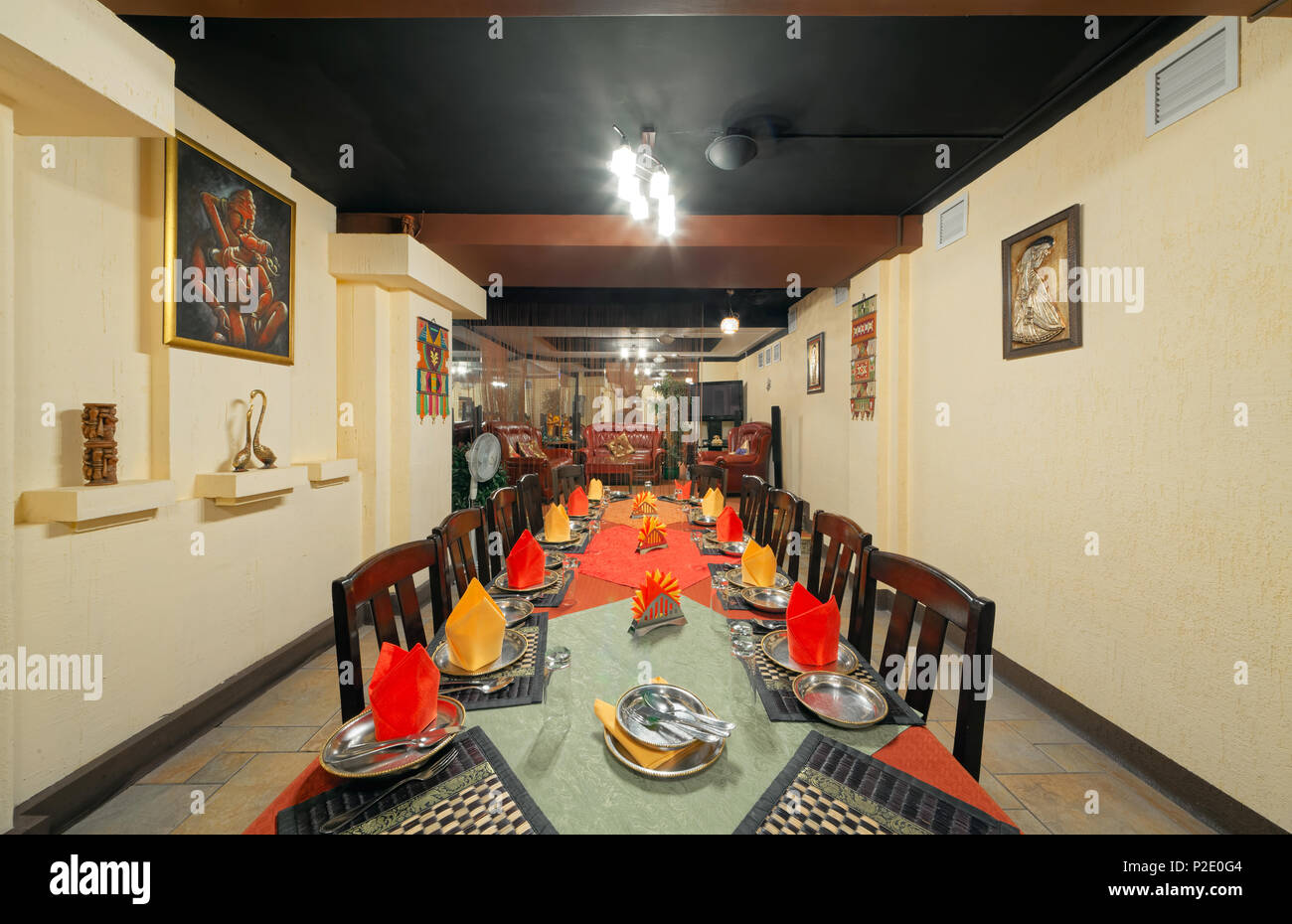 MOSCOW - SEPTEMBER 2014: Interior and furnishings of the restaurant of Indian cuisine 'KHAJURAHO'. Long served table in the banquet hall Stock Photo