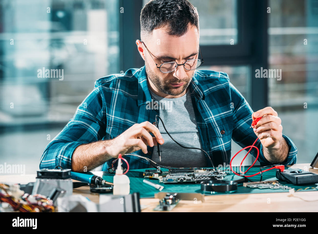 Repairman testing circuit board with multimeter Stock Photo Alamy