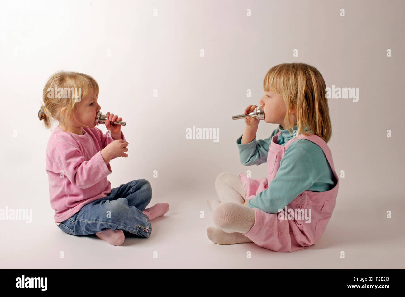 Two children with Brass mouthpieces. Music and children Stock Photo