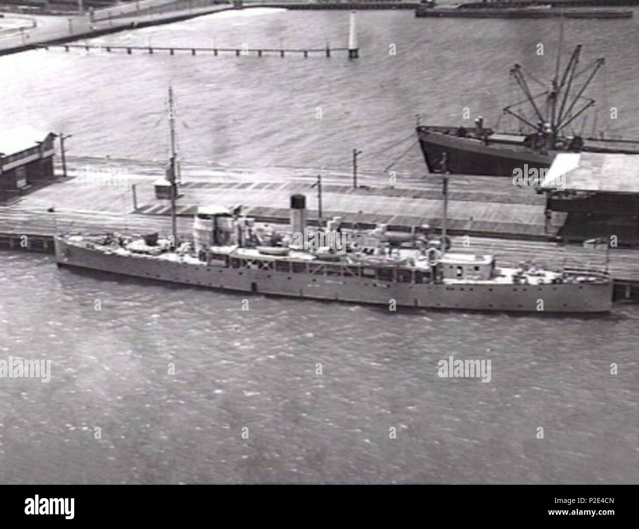 . English: AWM caption: Port Melbourne, VIC. 1940-02-01. Aerieal port side view of the former Royal Navy convoy sloop and RAN survey vessel HMSA Moresby (I) (ex HMS Silvio) during her first period of World War 2 service as an auxiliary anti-submarine vessel (1939–1940). She is armed with a 4 inch gun forward and depth charge rails and throwers aft. Note the protective p[lating around the forward superstructure. (Naval Historical Collection) . 1 February 1942. Unknown 25 HMAS Moresby 301056 Stock Photo