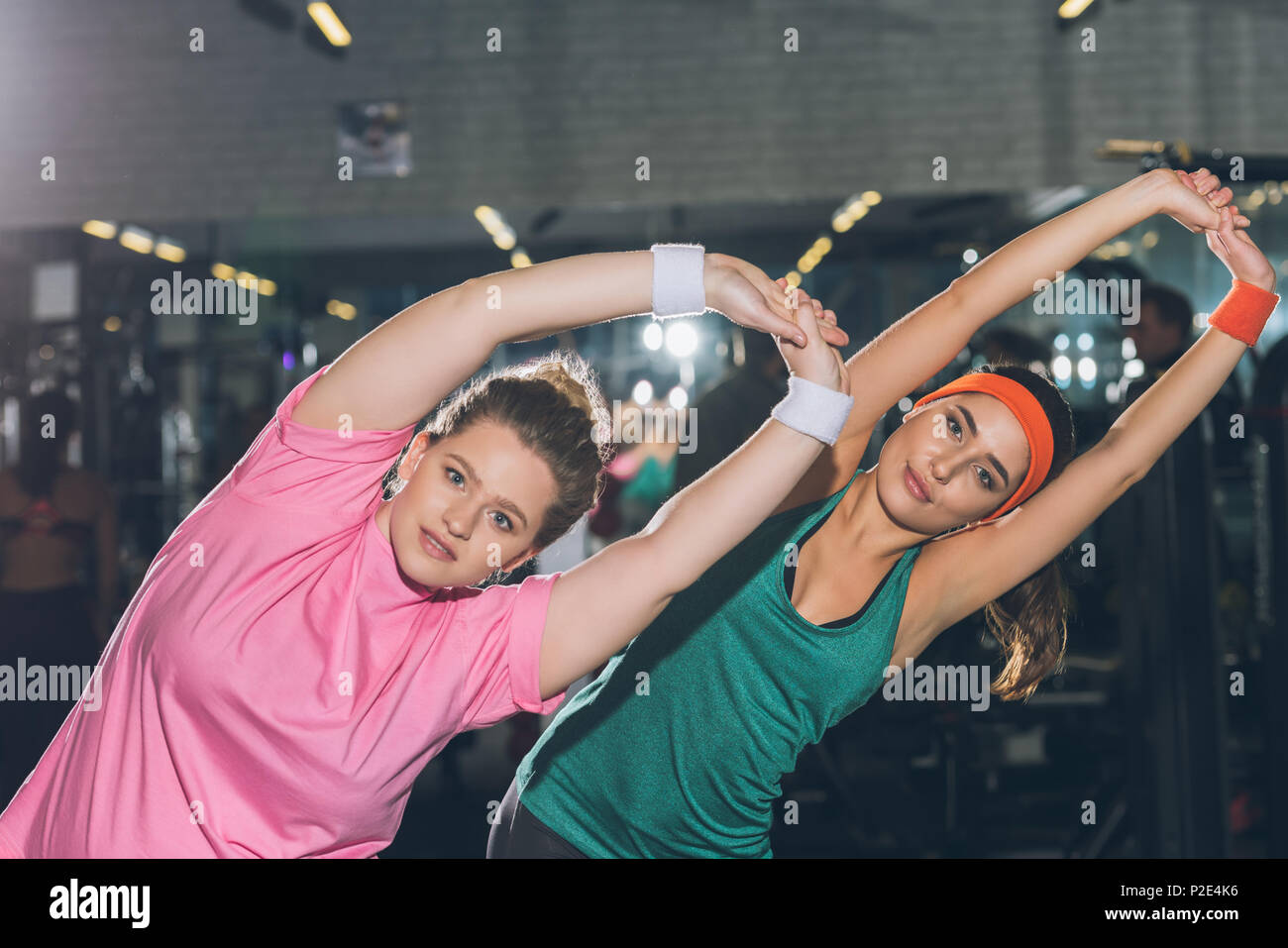 women at gym doing stretching exercises Stock Photo