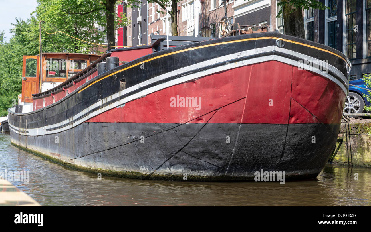 Black & Red Houseboat on Herengracht Canal, Amsterdam Stock Photo