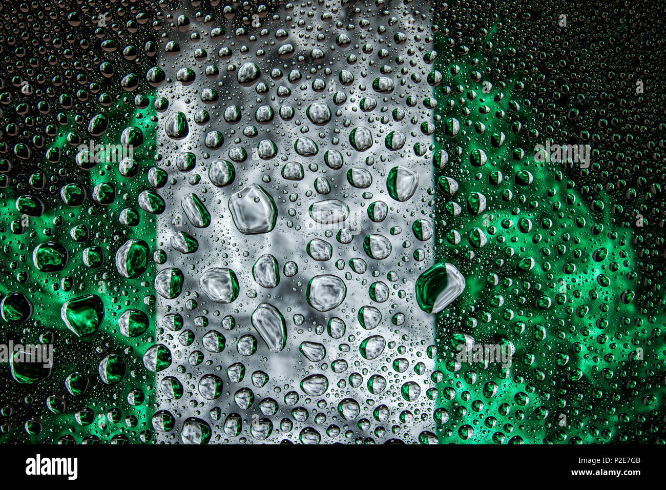 Close-up of a drop of water against a background of the national flag ...