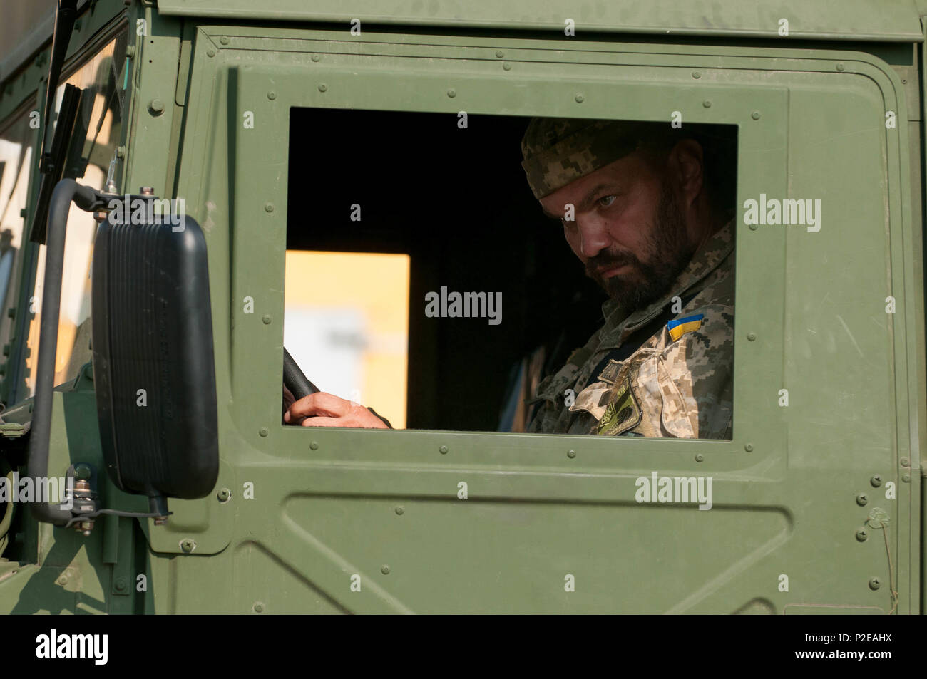 A Ukrainian Solider watches for hand signals during a ground guide exercise  of field litter ambulance familiarization on the driving range at Yavoriv  Training Area, Ukraine on Sep. 9, 2016. A team