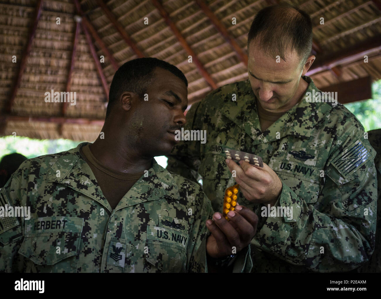 CABANAS, El Salvador (Sep. 1, 2016) - Hospital Corpsman 1st Class Hasson Herbert, a preventive medicine technician, left, and Lt. Christian Johnroe, an environmental health officer, both assigned to Naval Environmental Preventive Medicine Unit 2, help Operation Blessing’s Medical Brigade set up a temporary pharmacy station in Chalatenango, El Salvador during Southern Partnership Station 2016 (SPS 16). Operation Blessing’s Medical Brigade is a nonprofit mobile patient care unit established to provide medical service to those affected by natural disasters and render aid to rural areas. SPS-16 is Stock Photo