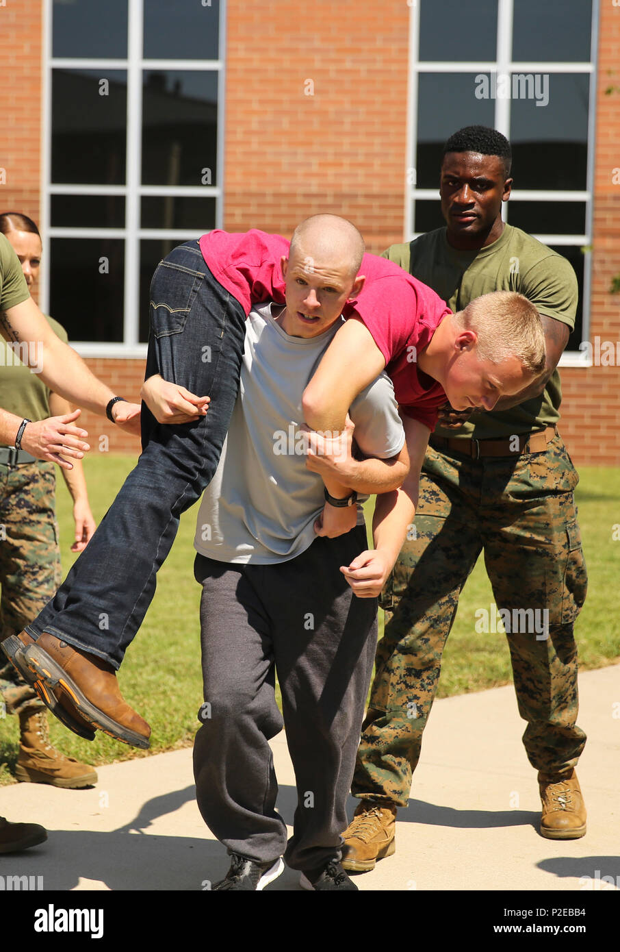 Cpl. Xavier Payne, a crash fire rescue Marine with Marine Wing Support Squadron 274, 2nd Marine Air Wing, based out of Marine Corps Air Station Cherry Point, assists high school students as they take on a mock combat fitness test at Stewart Creek High School in Smyrna, Tenn., Sept. 6, 2016. More than 800 Marines from all over the country travelled to Nashville in support of Marine Week to commemorate the unwavering support of the American people, and show the Marine Corps’ continued dedication to protecting the citizens of this country. (U.S. Marine Corps photo by Cpl. Kaitlyn V. Klein) Stock Photo