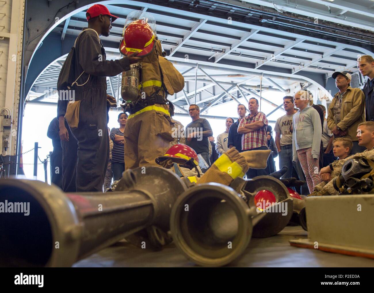 Damage Controlmen demonstrate the proper donning and operation of ...