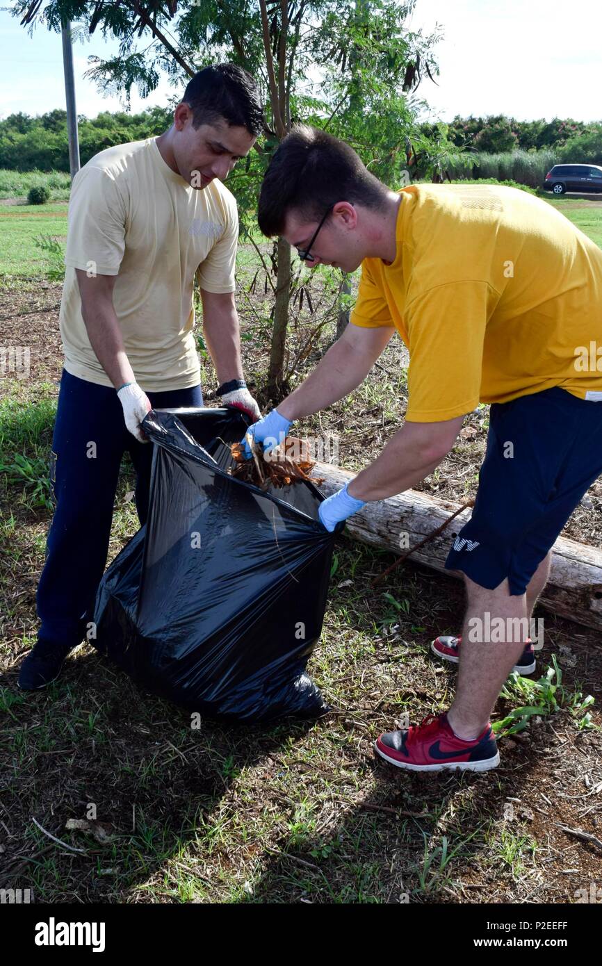 MANGILAO, Guam (Sept. 10, 2016) Electrician’s Mate 2nd Class Suresh Paudel and Electronics Technician 3rd Class Samuel Bronowski, both Sailors assigned to the submarine tender USS Emory S. Land (AS 39), pick up trash at Eagles Field in Mangilao, Guam during a community service event. Emory S. Land, homeported in Guam, conducts maintenance on submarines and surface ships in the U.S. 5th and 7th Fleet areas of operations. (U.S. Navy photo by Mass Communication Specialist Seaman Daniel S. Willoughby/RELEASED) Stock Photo