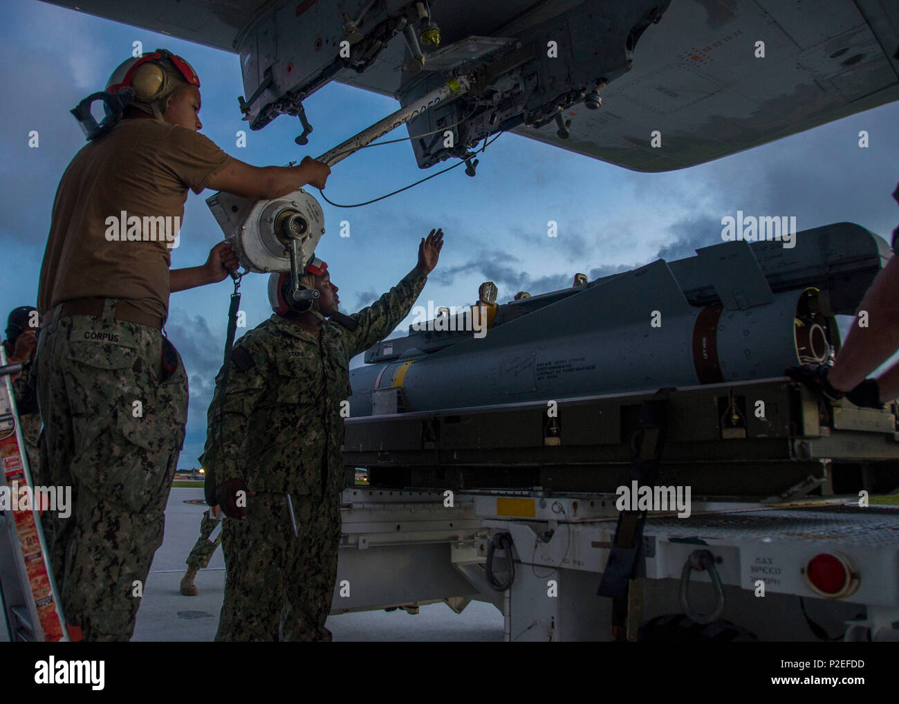 GUAM (September 13, 2016) – Aviation Ordnanceman 3rd Class Donta Stone and Aviation Ordnanceman Airman Ederson Corpus assigned to Patrol Squadron (VP) 46 load an AGM-65F Maverick air-to-surface missile on a P-3C Orion aircraft during Exercise Valiant Shield. Valiant Shield focuses on integrated joint training among U.S. military forces, enabling real-world proficiency in sustaining joint forces and in detecting, locating, tracking and engaging units at sea, in the air, on land and cyberspace in response to a range of mission areas. (U.S. Navy photo by Mass Communication Specialist 3rd Class Al Stock Photo