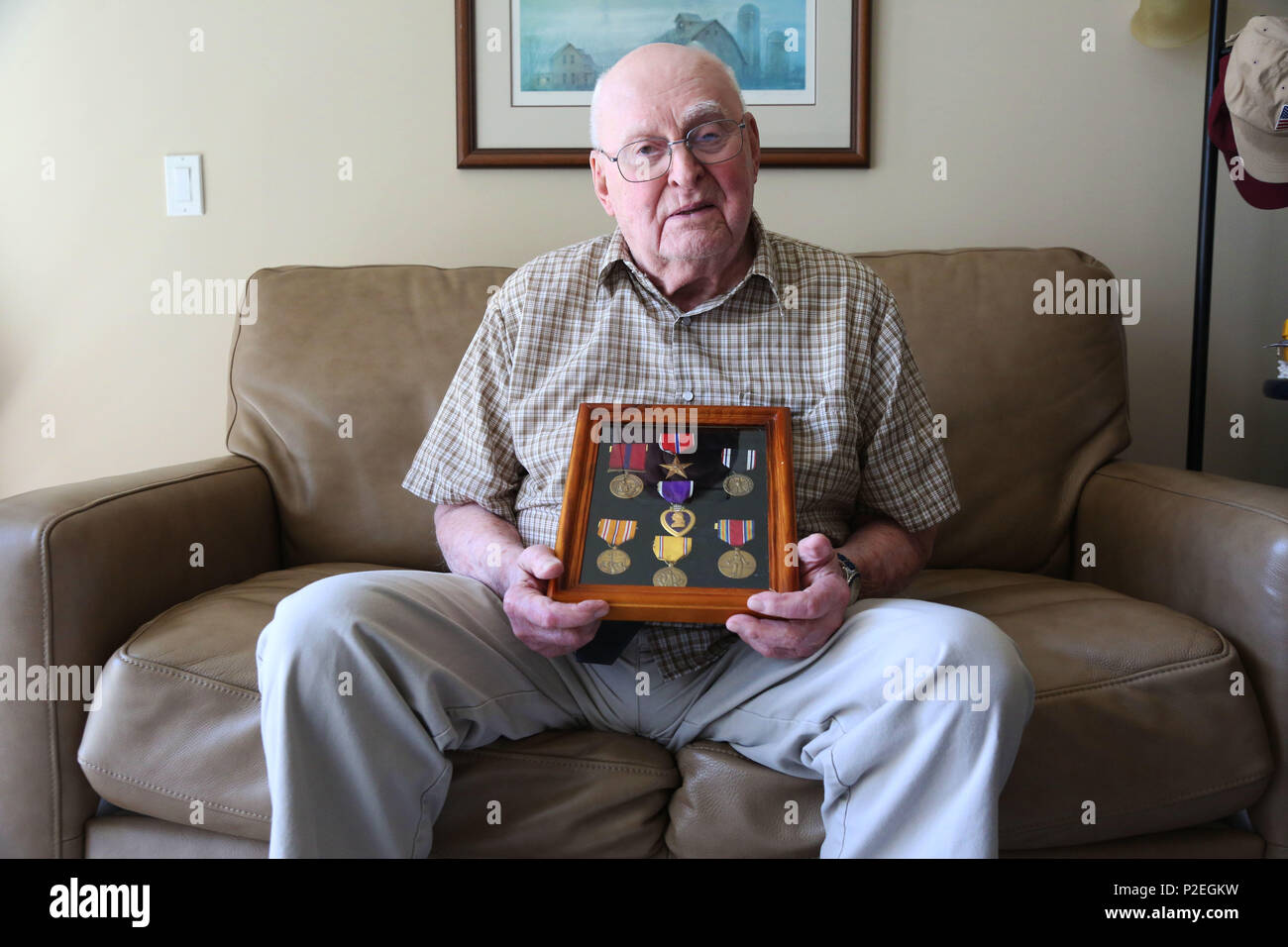 Former Marine Sgt. Warren Jorgenson, 96, holds the medals he was awarded during World War II, where he was taken by Japanese soldiers as a prisoner of war. Jorgenson spent years as prisoner before being liberated in September 1945. (U.S. Marine Corps photo by Cpl. Jennifer Webster/Released) Stock Photo