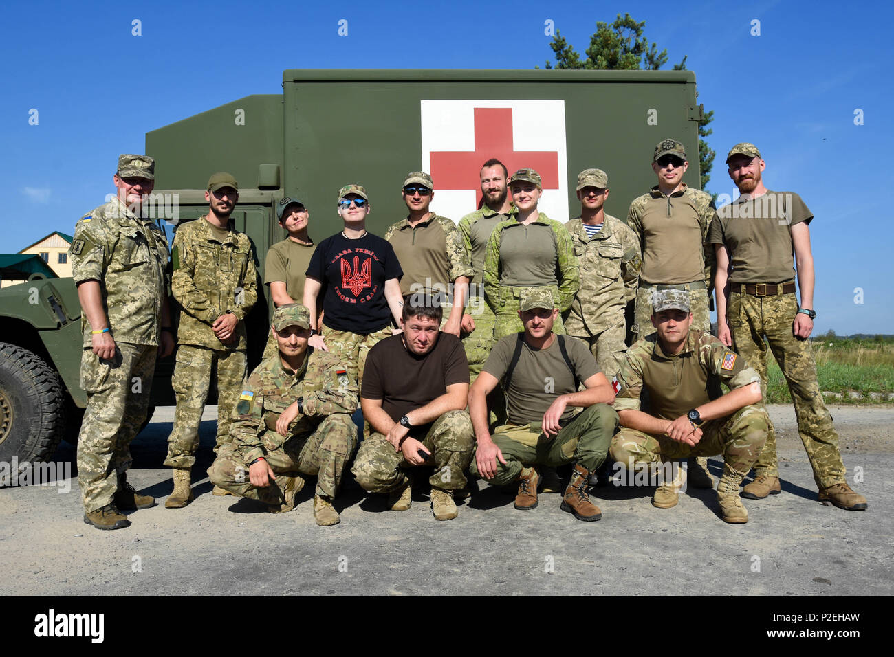 Ukrainian Soldiers pose for a group photo after the first day of learning how to drive the new field litter ambulances at Yavoriv Training Area, Ukraine on Sep 8, 2016. A team of medics and a mechanic from 557th Medical Company (Area Support) and 212th CSH are working together to conduct field littler ambulance and medical equipment set familiarization with the Ukrainian military from Sep 5 to 16, 2016. (U.S. Army photo by Capt. Jeku Arce, 30th Medical Brigade Public Affairs) Stock Photo