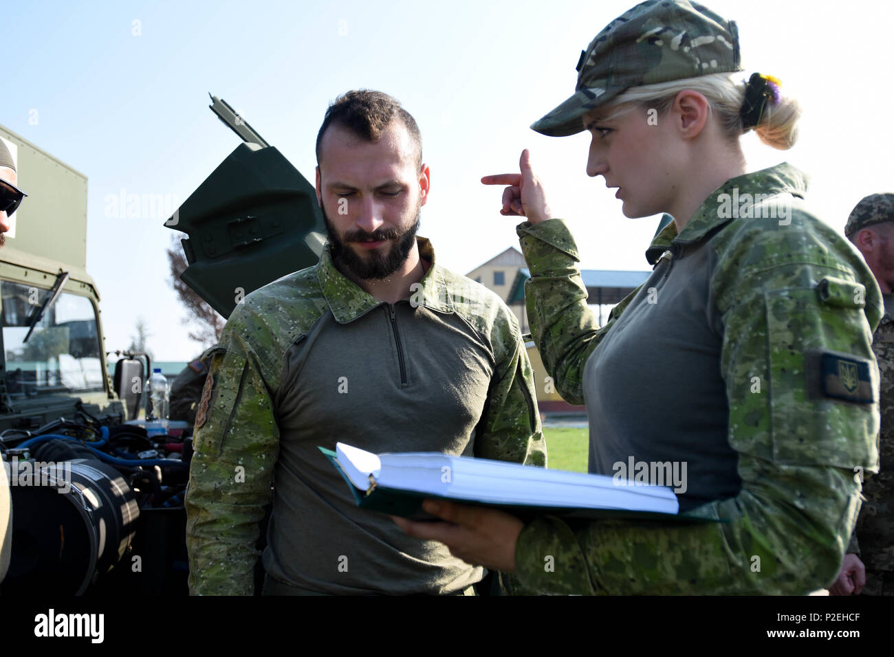 A Ukrainian Soldier uses a field litter ambulance inspection checklist as a guideline while her partner conducts the inspection on the new FLA at Yavoriv Training Area, Ukraine on Sep 8, 2016. A team of medics and a mechanic from 557th Medical Company (Area Support) and 212th CSH are working together to conduct field littler ambulance and medical equipment set familiarization with the Ukrainian military from Sep 5 to 16, 2016. (U.S. Army photo by Capt. Jeku Arce, 30th Medical Brigade Public Affairs) Stock Photo