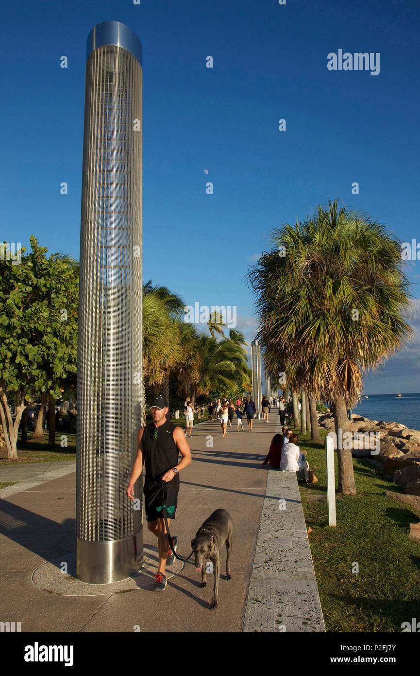 United States, Florida, Miami, Jogger walking his dog, on the walk of South Point, in front of South Point Park, in the district of South Beach, in Miami Beach Stock Photo