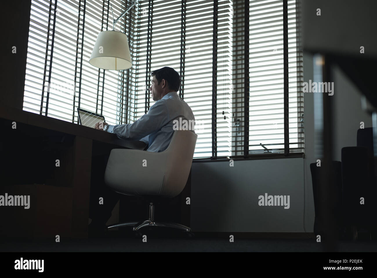 Businessman using laptop at table Stock Photo