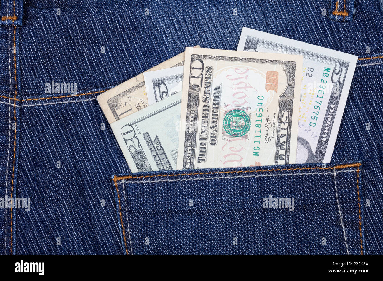 A few US dollar bills sticking out of the back pocket of his trousers. Stock Photo